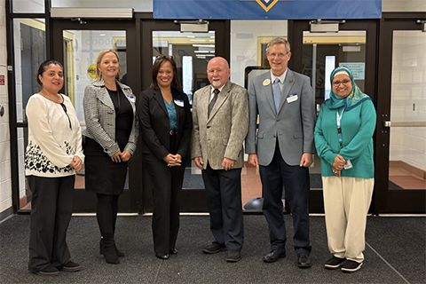 A group photo of Interim Provost Dr. Kevin Corcoran and School of Education and Human Services Dean Dr. Jon Margerum-Leys and others at Universal Academy